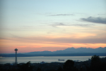 The Space Needle and Olympic Mountains from the Volunteer Park Water Tower at sunset