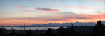 The Space Needle and Olympic Mountains from the Volunteer Park Water Tower at sunset
